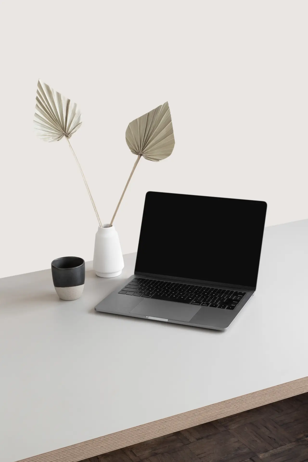 Laptop on a clean desk with dried botanicals
